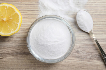 Baking soda and lemon on wooden table, top view