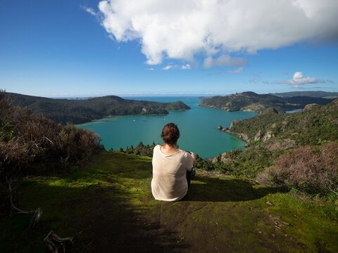 Female traveller admiring blue ocean water panorama, Whangaroa harbour Kaiaraara Rocks Dukes Nose, Northland New Zealand