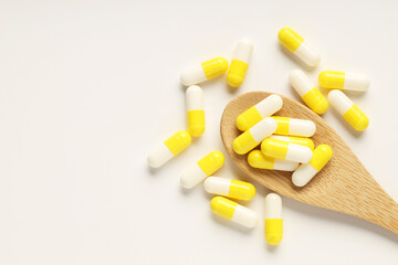Antibiotic pills and spoon on white background, top view. Space for text
