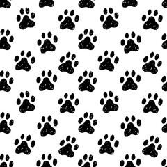 Fototapeta premium Black animal paw prints seamless pattern on white backfround. Sketchy, rugged, textured pet paw prints simple endless pattern for textile, paper design.