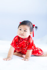 Girl in Chinese New Year costume,Happy Little asian girl in chinese traditional dress laughing and smiling.