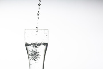 Pouring water into a glass on a white background. Close-up image,Glass of drinking water isolated on white background,