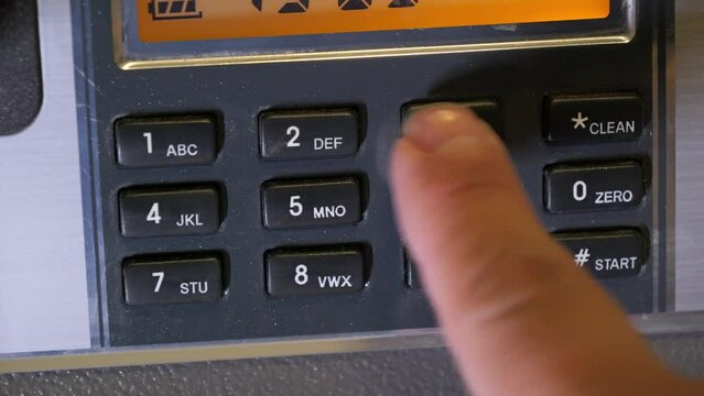 A man enters the correct code into the keypad of a safe, unlocking its door,Financial security concept