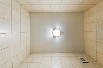 suspended ceiling with halogen spots lamps and drywall construction in empty room in apartment or house. Stretch ceiling white and complex shape.