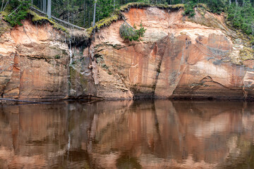 landscape with sandstone cliffs on the river bank, sandy river bank, old last year's grass, nature...