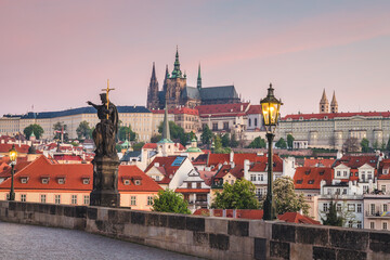 Obraz premium Prague Castle, view from Charles bridge with a lighted lamps early morning before sunrise, Prague, Czech Republic, Europe.