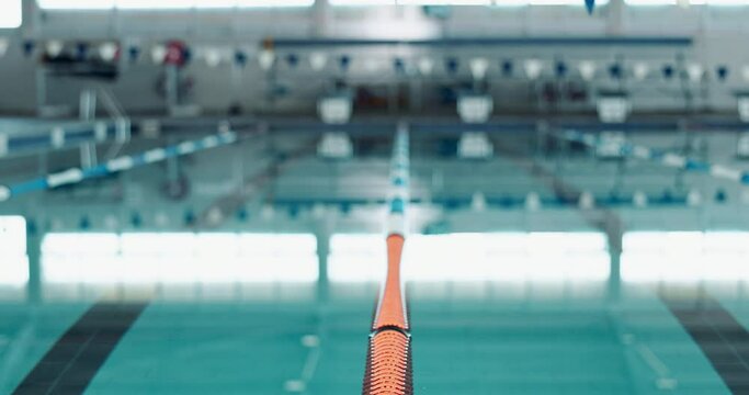 Indoor, empty swimming pool and lane rope for competition or fitness with exercise for health. Calm, liquid and divider for aquatic training with professional sport, reflection and racing in centre