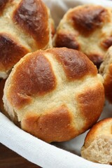 Hot cross buns in basket on table, closeup