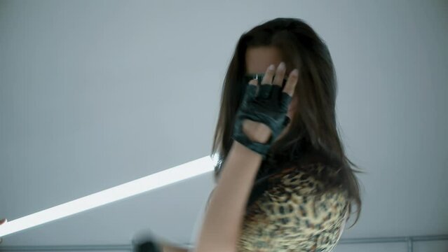Girl in a leopard print dress and sunglasses dancing in smoke