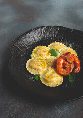 ravioli with shrimp, in cream sauce, with spices and herbs, top view, no people,