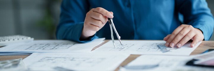 Interior architect working with blueprint planning in modern office, engineering concept