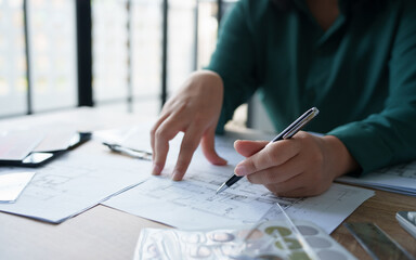 Interior architect working with blueprint planning in modern office, engineering concept