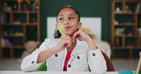 Face, child or girl thinking in home for education, homework and learning with smile. Studying kid, notebook and pen in house for numbers, childhood development and maths on table with commitment