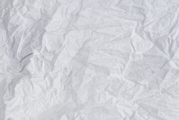 Crumpled white paper background.