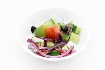 Juicy fresh salad in a bowl. Cucumbers, tomatoes and olives.