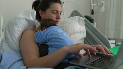 Mother in hospital bed with newborn baby, working on laptop, blending remote work and parenting,...