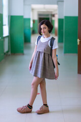 Beautiful girl in a school corridor posing for the camera