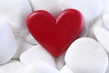 Decorative heart on white pebble stones, above view