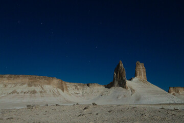 Night scene with the rock pinnacles of Bozzhira valley, Kazakhstan