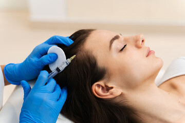 Injection hair follicles with special cosmetology syringe. Mesotherapy process.