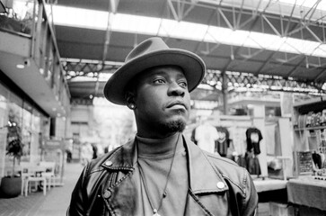 Fototapeta premium Close black and white portrait of man in a street market.