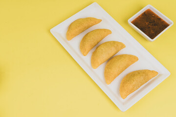 Colombian empanada with spicy sauce 