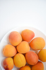 Yellow plums on a white plate. Fresh fruits.