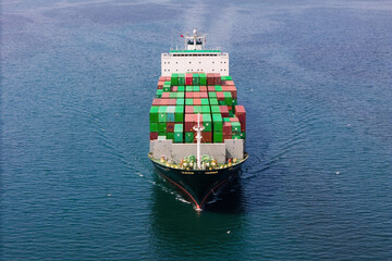 Loaded Container ship cruising across sea for logistics import export, Aerial view