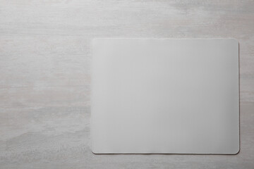 One mouse pad on grey wooden table, top view. Space for text