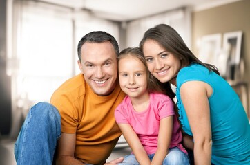 Portraif Of Happy Parents Posing With child At Home,