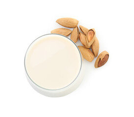 Glass of almond milk and almonds isolated on white, top view