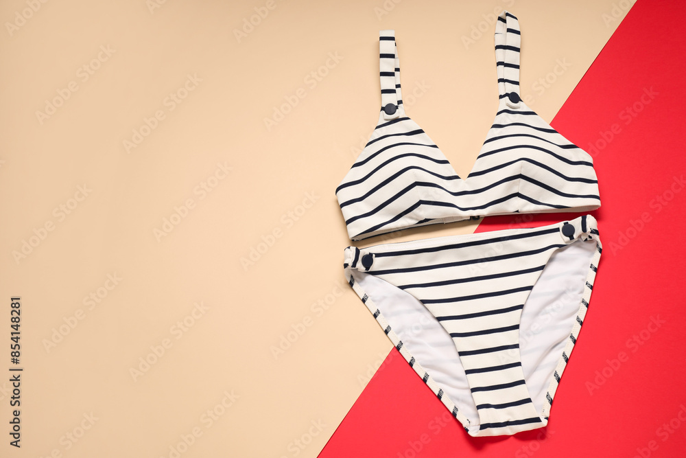 Sticker Striped swimsuit on color background, top view. Space for text