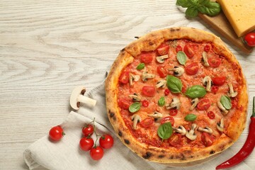 Delicious pizza with tomatoes, mushrooms and basil on wooden table, flat lay. Space for text