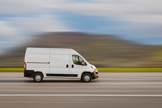 Cargo van is driving on the highway at speed with a blurred background. Freight transport, commercial transport concept with free space for text, copy space