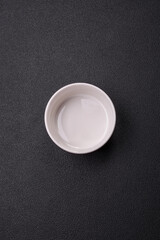 Beautiful empty white ceramic gravy boat on a concrete background