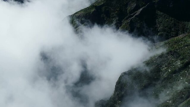 clouds rolling into mountains madeira 