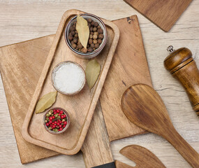 White salt, peppercorns on the table, top view.
