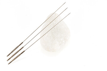 Silver needles for traditional Chinese medicine acupuncture. Close-up. Isolated white background. There is some free space for your text or sign.