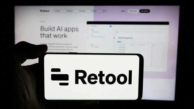 Stuttgart, Germany - 06-05-2024: Person holding cellphone with logo of US software development company Retool Inc. in front of business webpage. Focus on phone display.