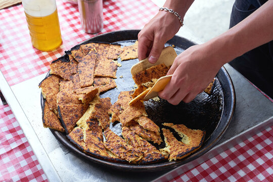 Socca, just coming out of the oven, in Nice, the French Riviera. a type of thin, Socca is a specialty of southeastern French cuisine. a pancake made from chickpea flour.