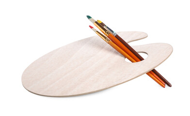 Brushes with paints and wooden palette isolated on white