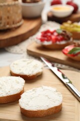 Delicious bruschettas with ricotta cheese on table, closeup