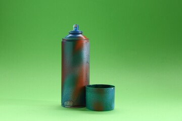Fototapeta premium Spray paint can with cap on green background