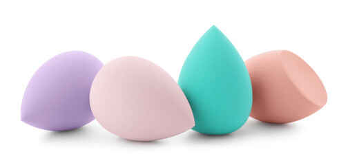 Many colorful makeup sponges isolated on white