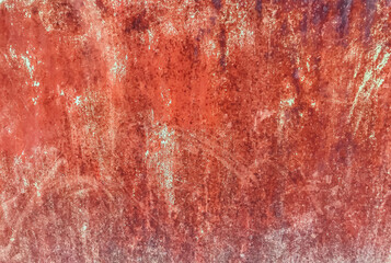 A red wall with a lot of dirt and grime on it