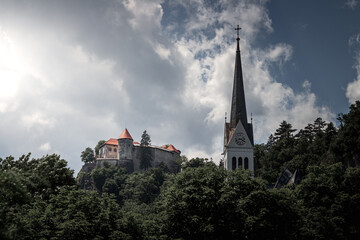 A Bled castle old medival on the high cliff rock near the lake. Church top on the right.