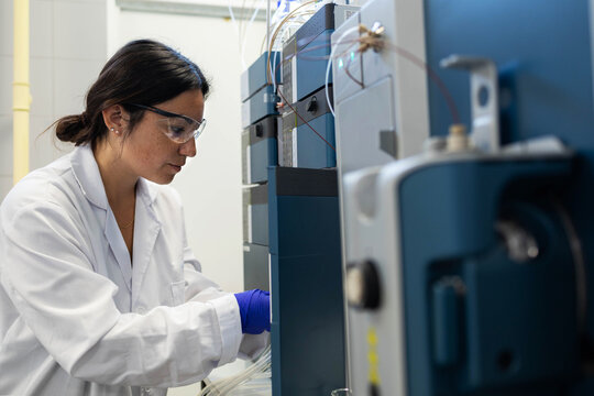 a woman scientist analyzing samples in a laboratory
