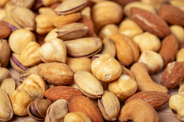Mixed nuts on wooden background. Close up
