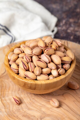 Pistachios on wooden background. Pistachios in a bowl
