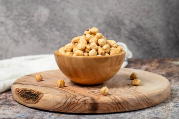 Hazelnuts on wood background. Roasted hazelnuts in a bowl